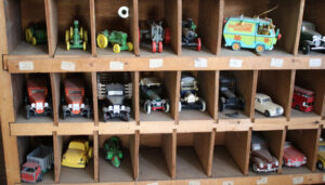 Nested model cars in Ray J’s corner shop in Newark, where Ray Delue sells parts and accessories for American motorcycles. He has one display of cars above the parts desk, and this one is next to it. 