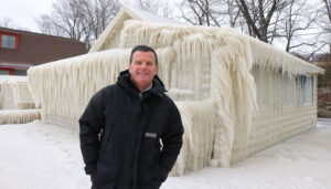 John Kucko stands by a frozen building in Webster near Lake Ontario. Courtesy of John Kucko.