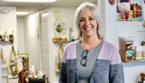 Amy Stringer, 55, of Ontario, quit her job as an accountant for a Victor firm to open her business, The North Bee in Webster. “I have a joy doing this,” she says.