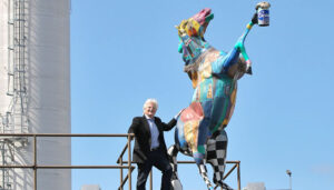 “Genny” who adorns — what else? — the Genesee Brewery, raises high a pint of Genny Light to greet the afternoon. Howie Jacobson, who was part of the team that resurrected Genesee through the Horses on Parade campaign in 2001, stands with Genny, which was designed by artist Anne Aderman. The theme of the community event fit happily with Genesee bringing back 12 Horse Ale.